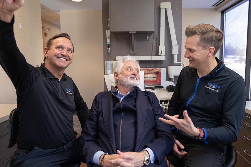 doctors with patient smiling