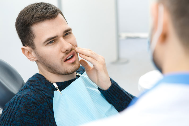 Dental Patient Suffering From Mouth Pain On A Dental Chair, In Plymouth, MN